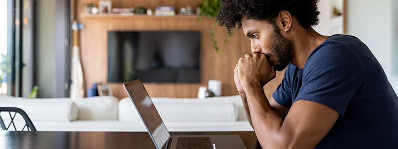 man learning online on laptop
