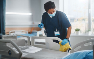 Healthcare professional cleaning a hospital room to demonstrate cleanliness benefits.