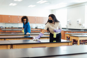 Janitor performing campus cleaning with advanced tools for a safe learning environment.