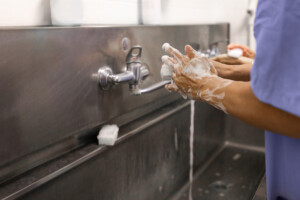 Cleaning team applying disinfectant as part of disinfection certification process.