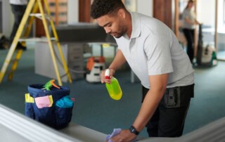 Cleaning team applying disinfectant as part of disinfection certification process.