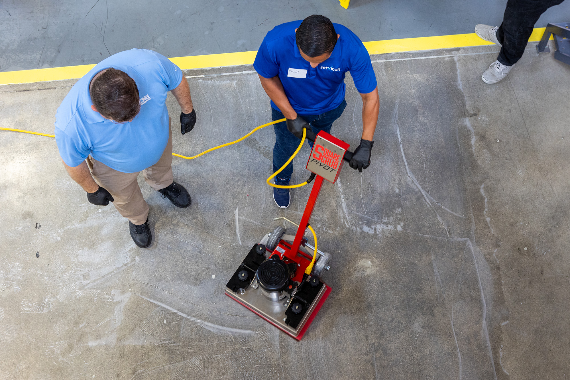 Member showing how to use equipment to another