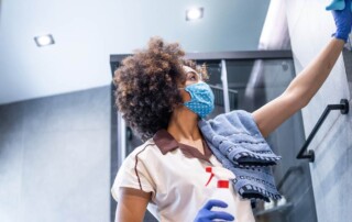 Cleaning technician with disinfection certificate disinfecting surface