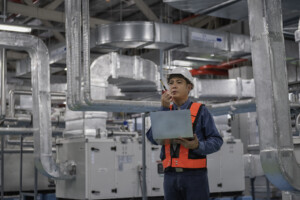 Technician and cleaner working together to maintain an indoor air quality system.