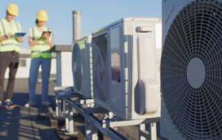 Technician checking commercial HVAC system to improve IAQ HVAC performance